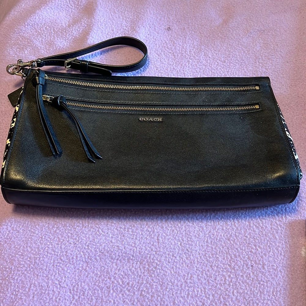 Coach black clutch with wrist strap.